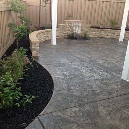 Concrete patio with planter boxes and landscaping