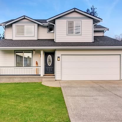House with concrete driveway and lawn