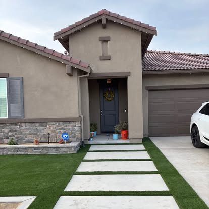 Home with concrete driveway and stepping stone walkway