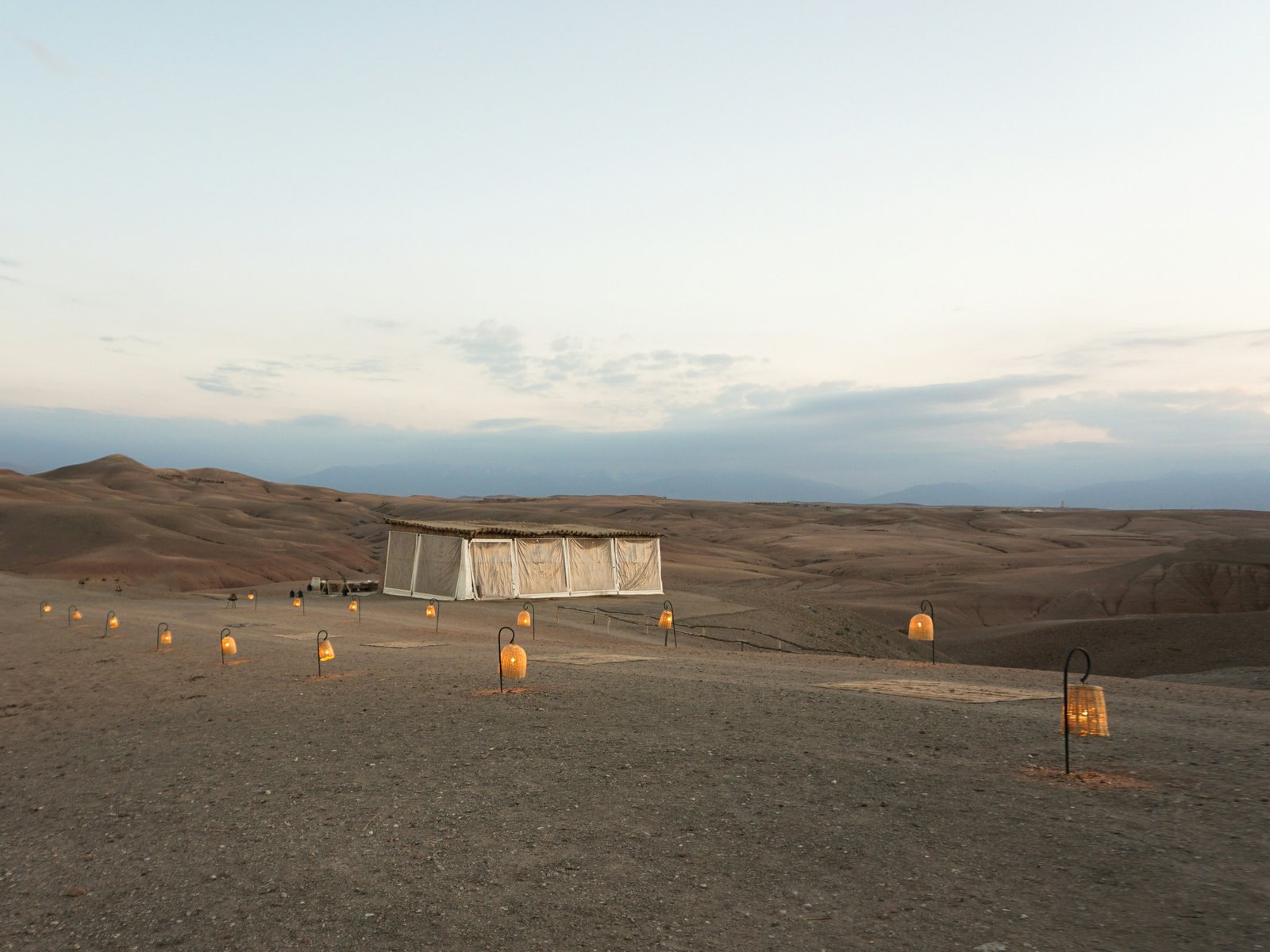 A luxury desert camp at sunset in the Agafay desert near Marrakech, Morocco
