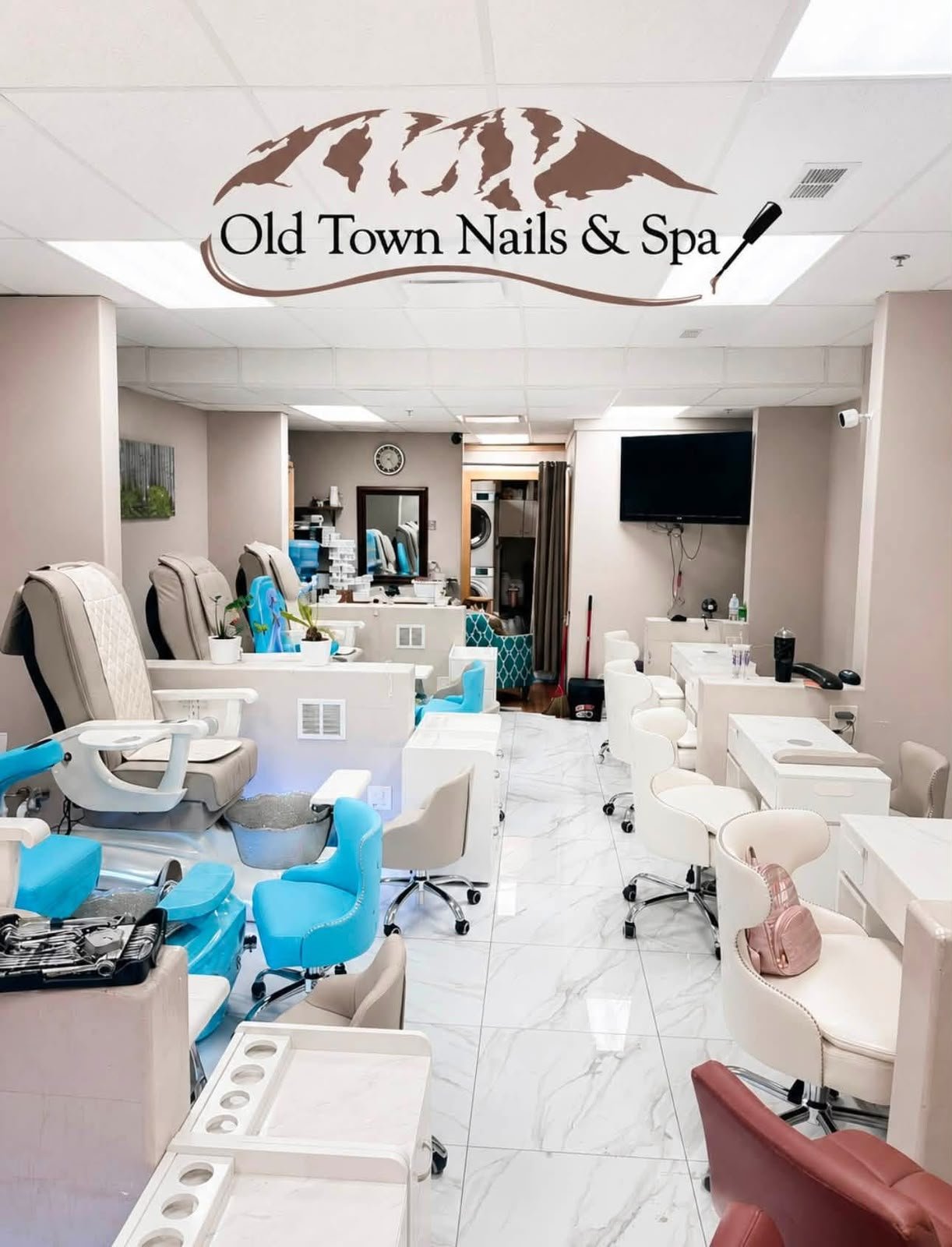Wide view of the real salon with manicure stations and pedicure chairs