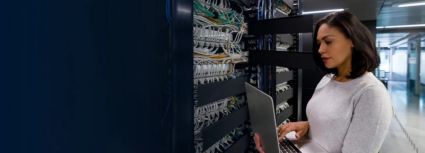 Professional team of IT engineers and network specialists collaborating around network infrastructure dashboards in modern corporate office