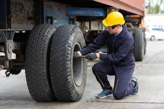Willie Tyres mobile service van changing a truck tyre on the roadside at night