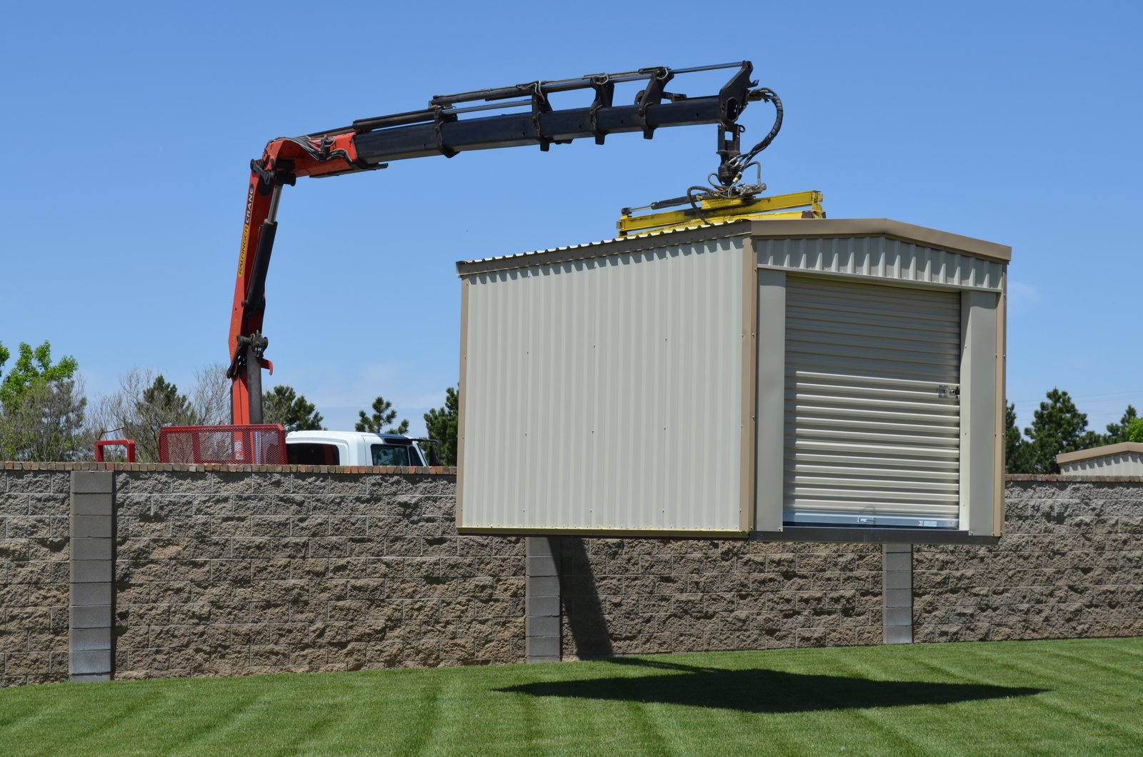 Portable all-steel storage building delivered by truck on a customer's property