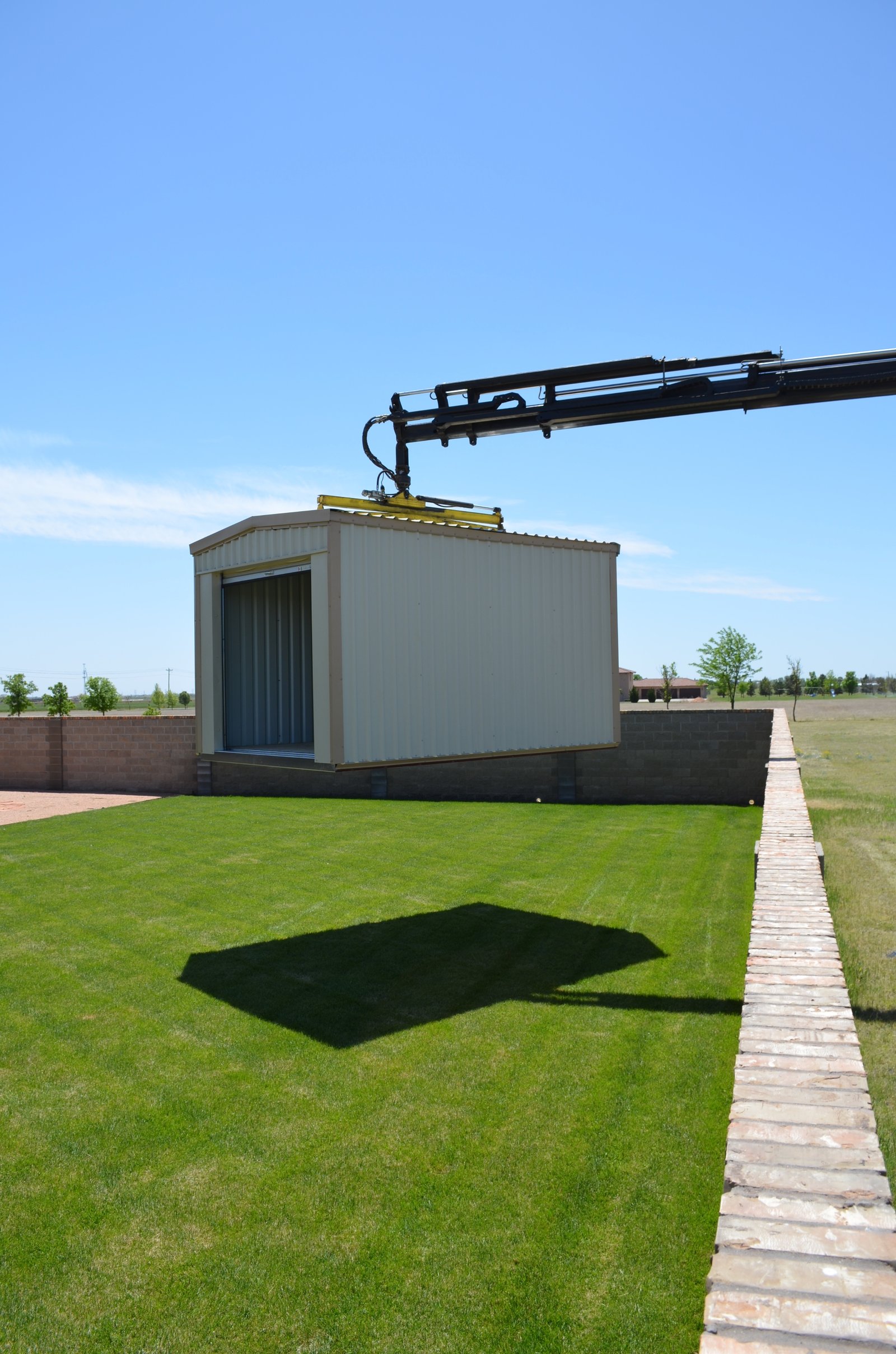 My Storage delivery truck placing a portable storage building at a customer's home