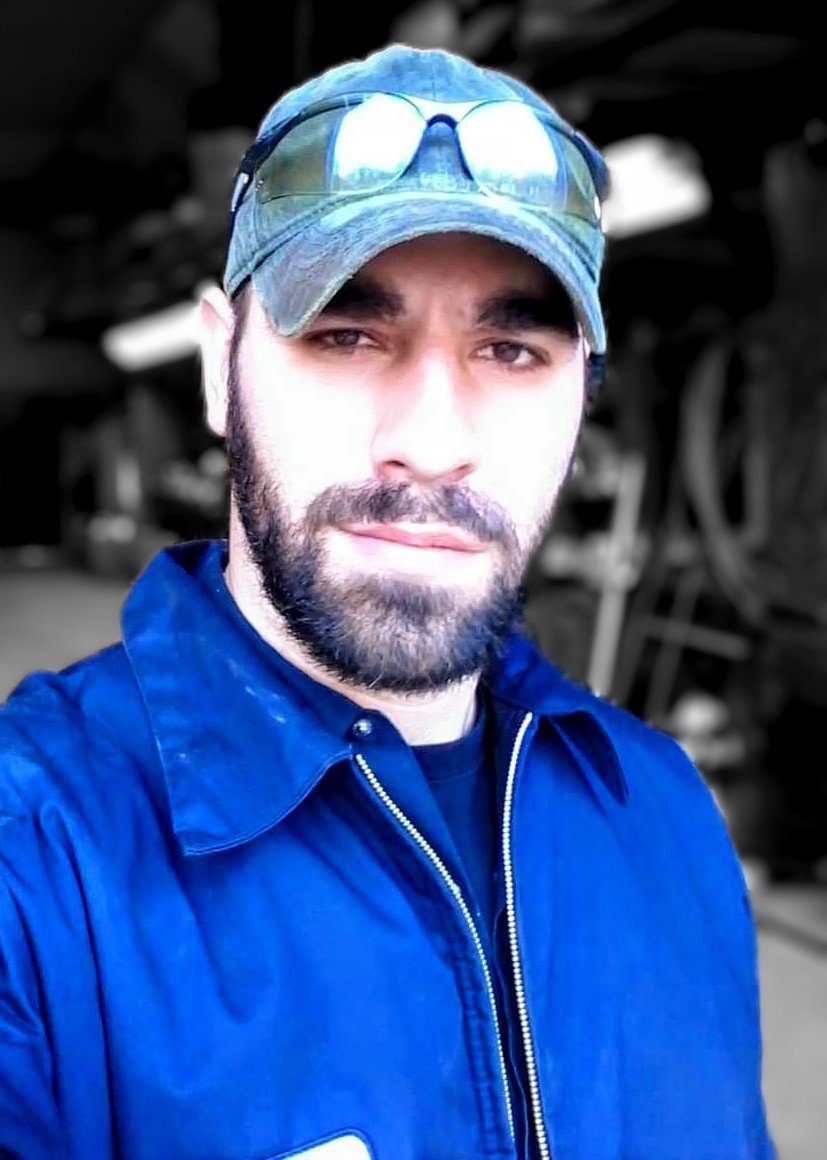 Rapid Roadside Rescue technician in a blue work jacket ready to respond