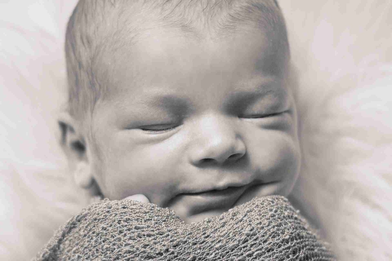 Smiling newborn baby face close up