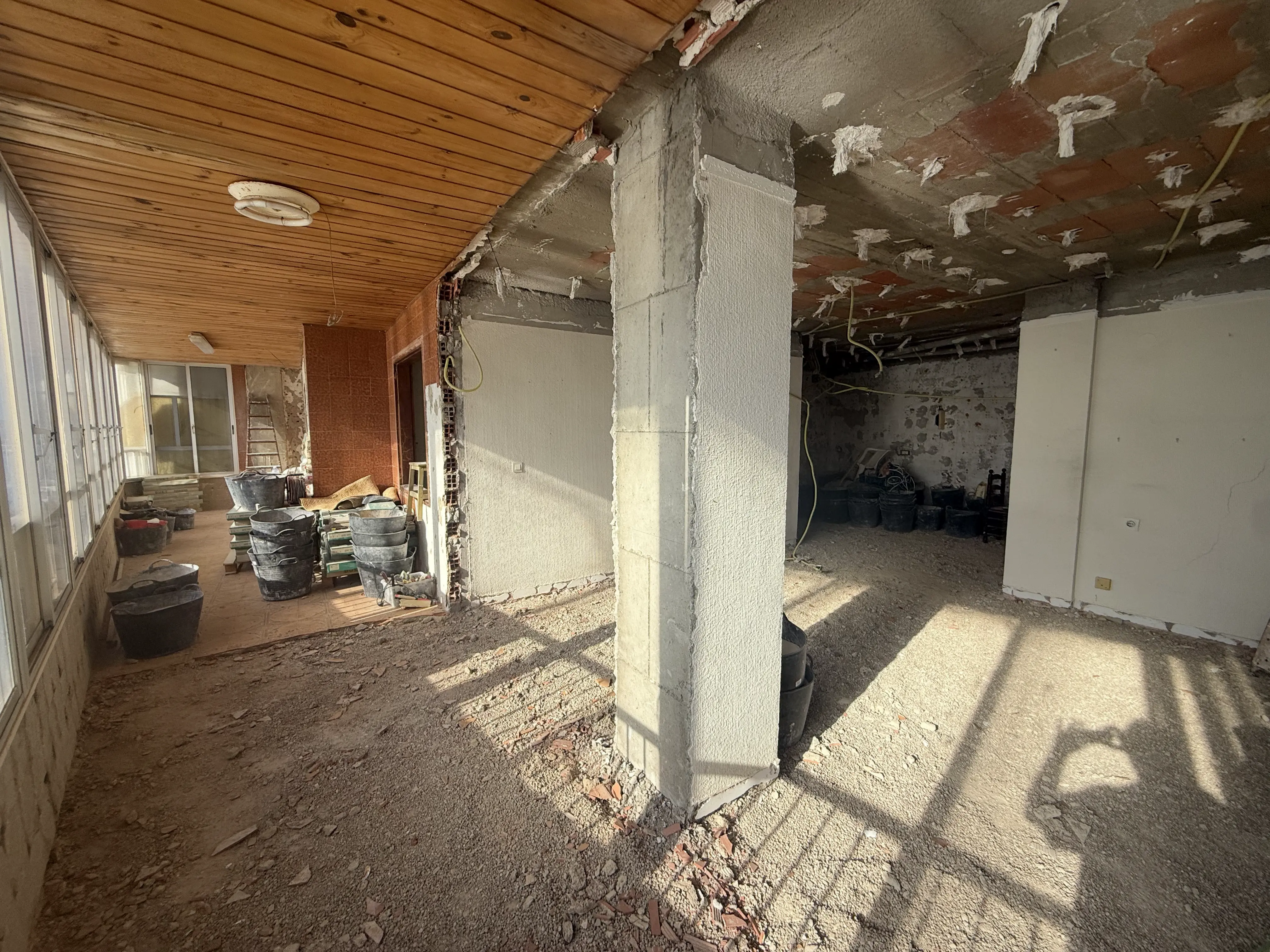 Renovation works in progress &mdash; new flooring being installed with dust sheets, tools and construction materials