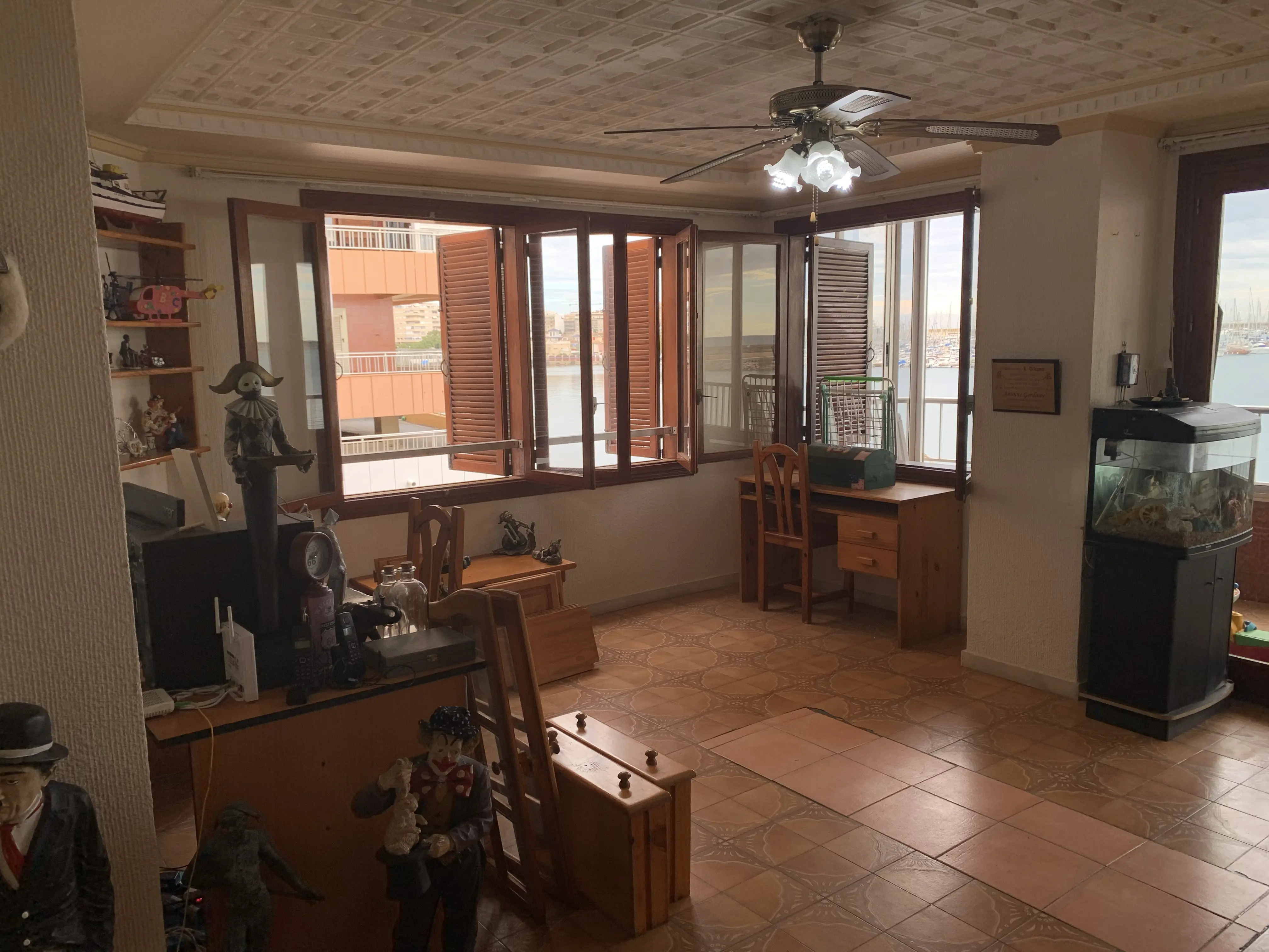 Living room before renovation — classic Costa Blanca flat with heavy furniture, small windows and dated finishes