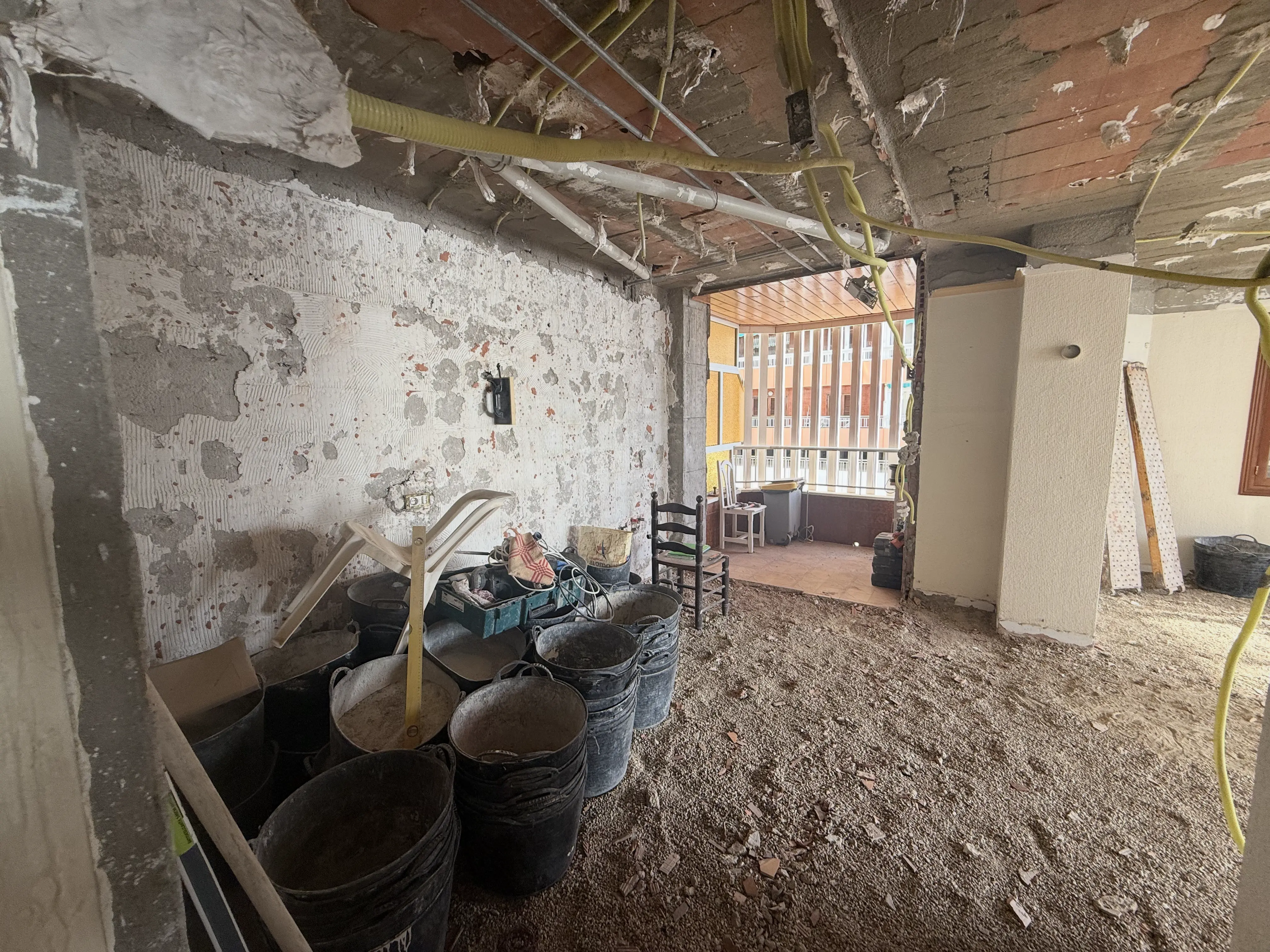 Renovation works in progress &mdash; new plaster walls, electrical wiring and finishing tools