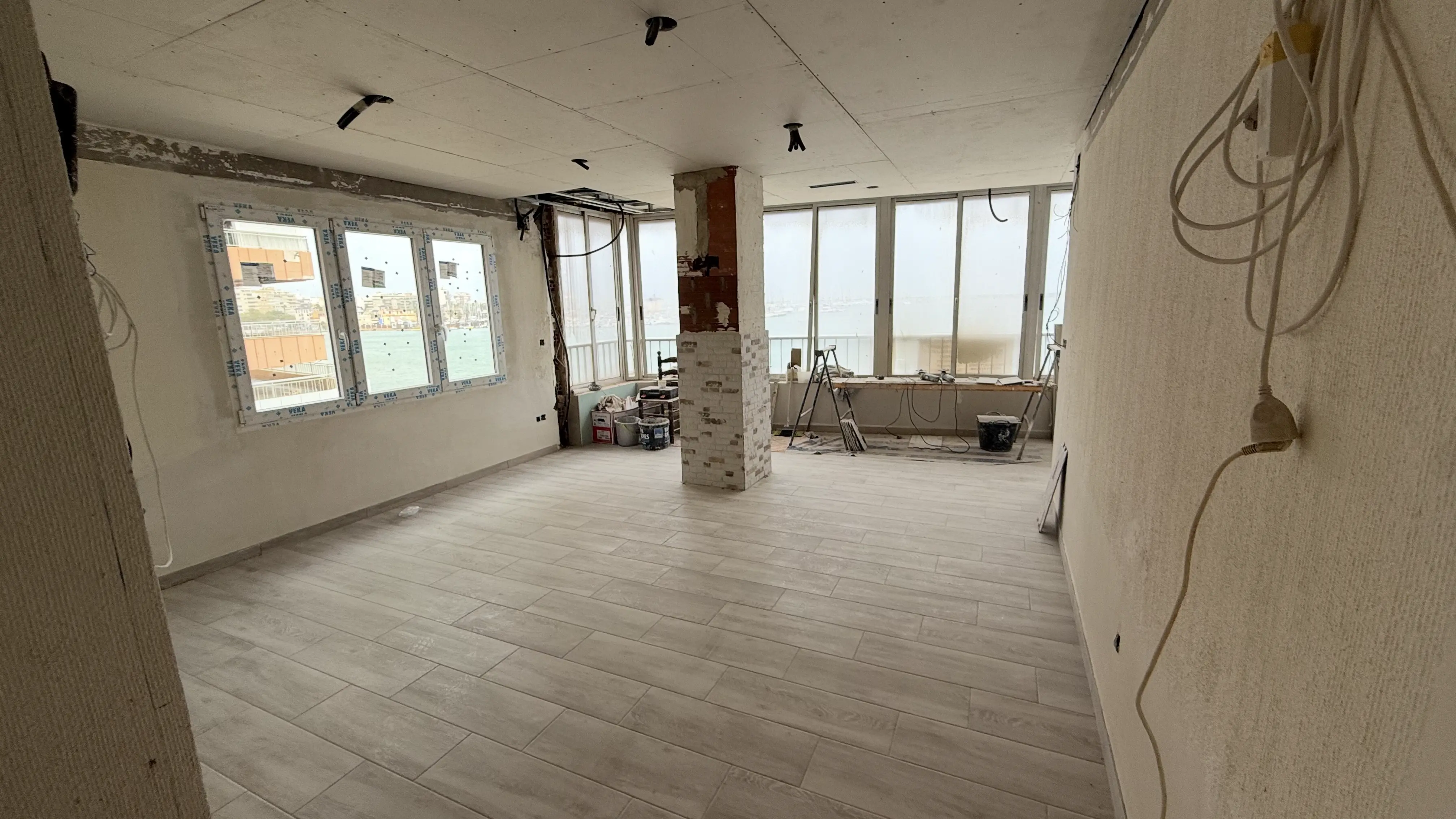 Renovation works in progress &mdash; freshly plastered walls, exposed wiring and painting equipment