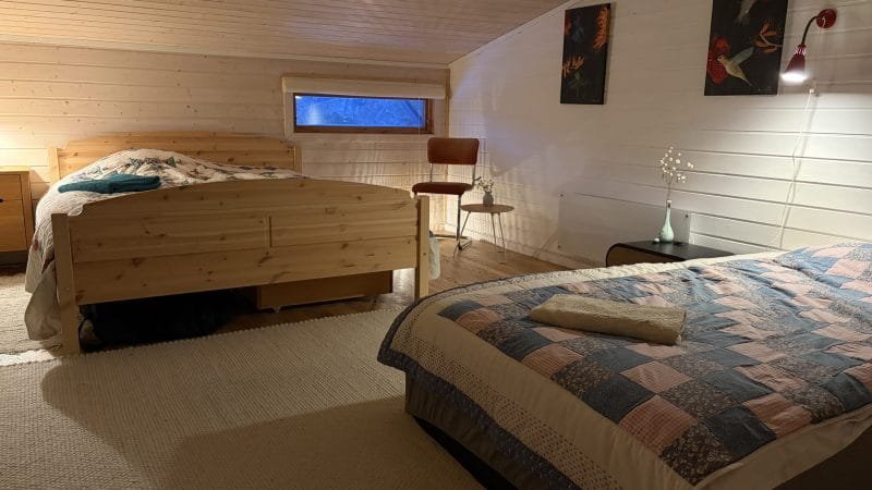 Bedroom with wooden beds, mountain view through window