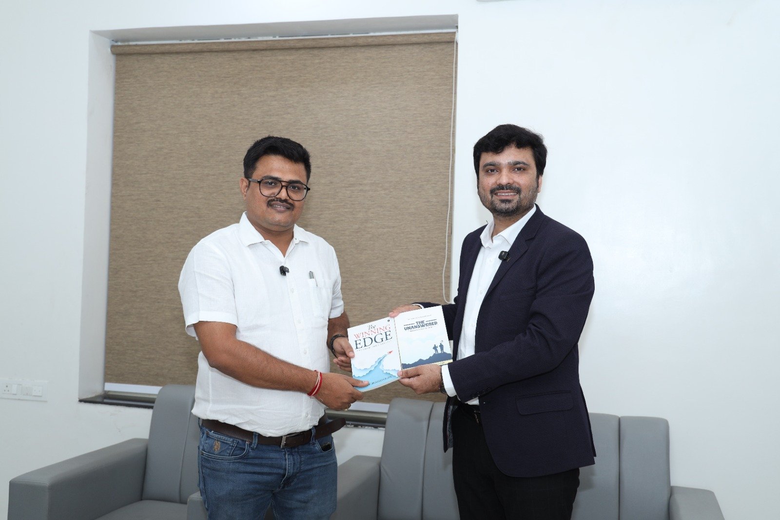 Avinash Chate presenting his books to a client