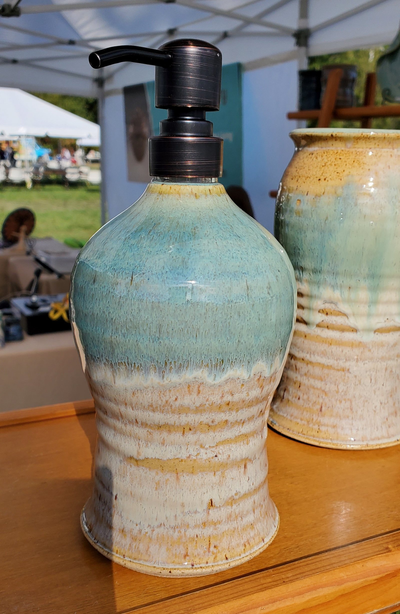 Soap dispenser with light cream and tan glaze with natural speckled texture