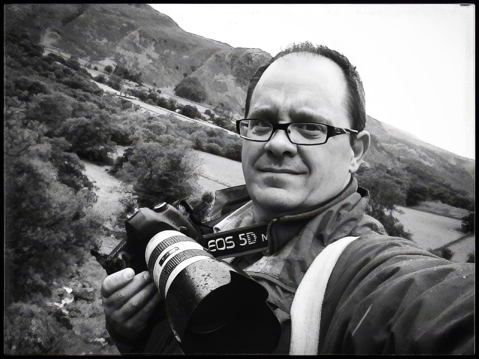 Doug Marke, photographer, with camera in the landscape