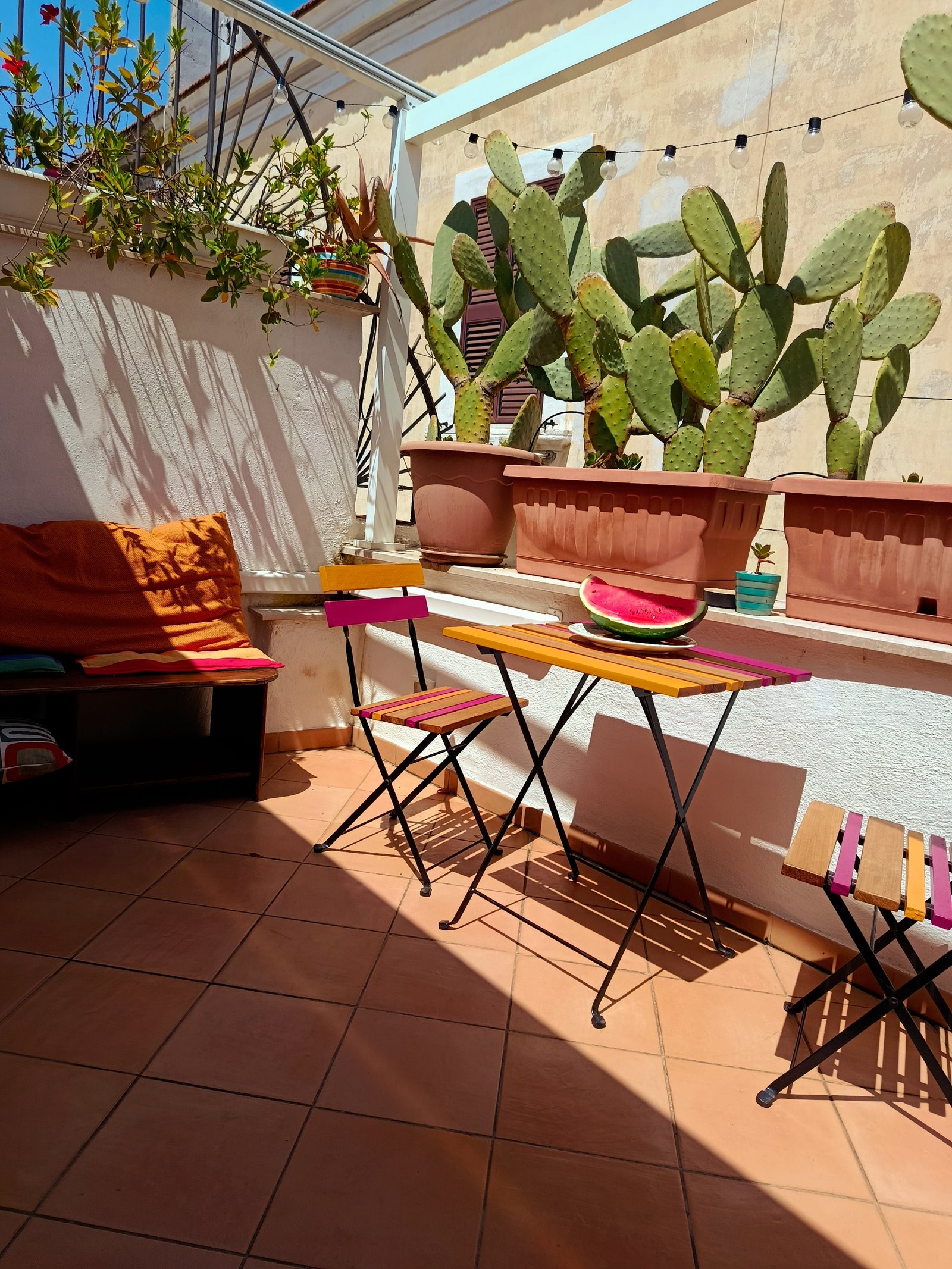 Terrace with prickly pears and a colourful side table