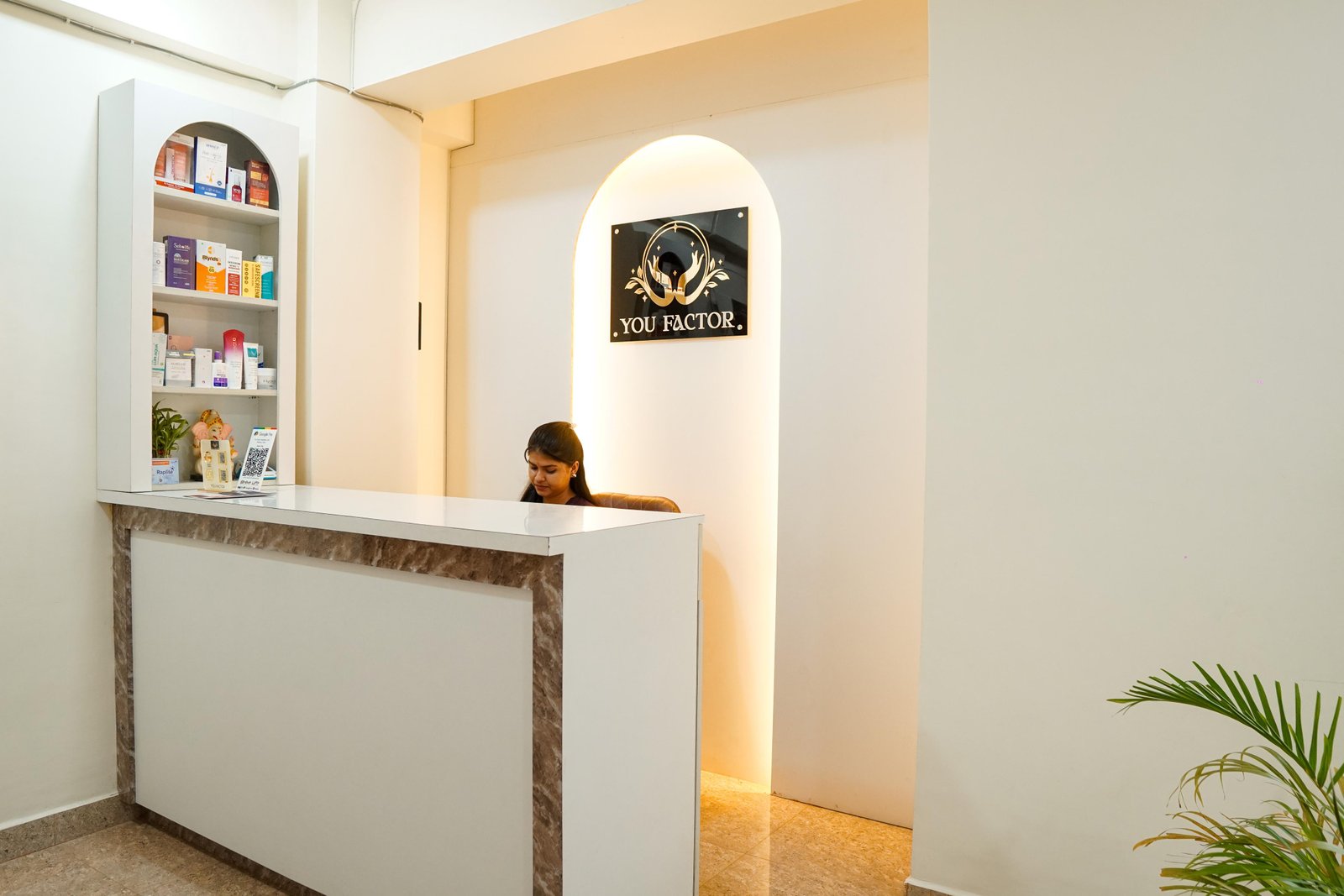 YOU FACTOR clinic reception desk with product shelves