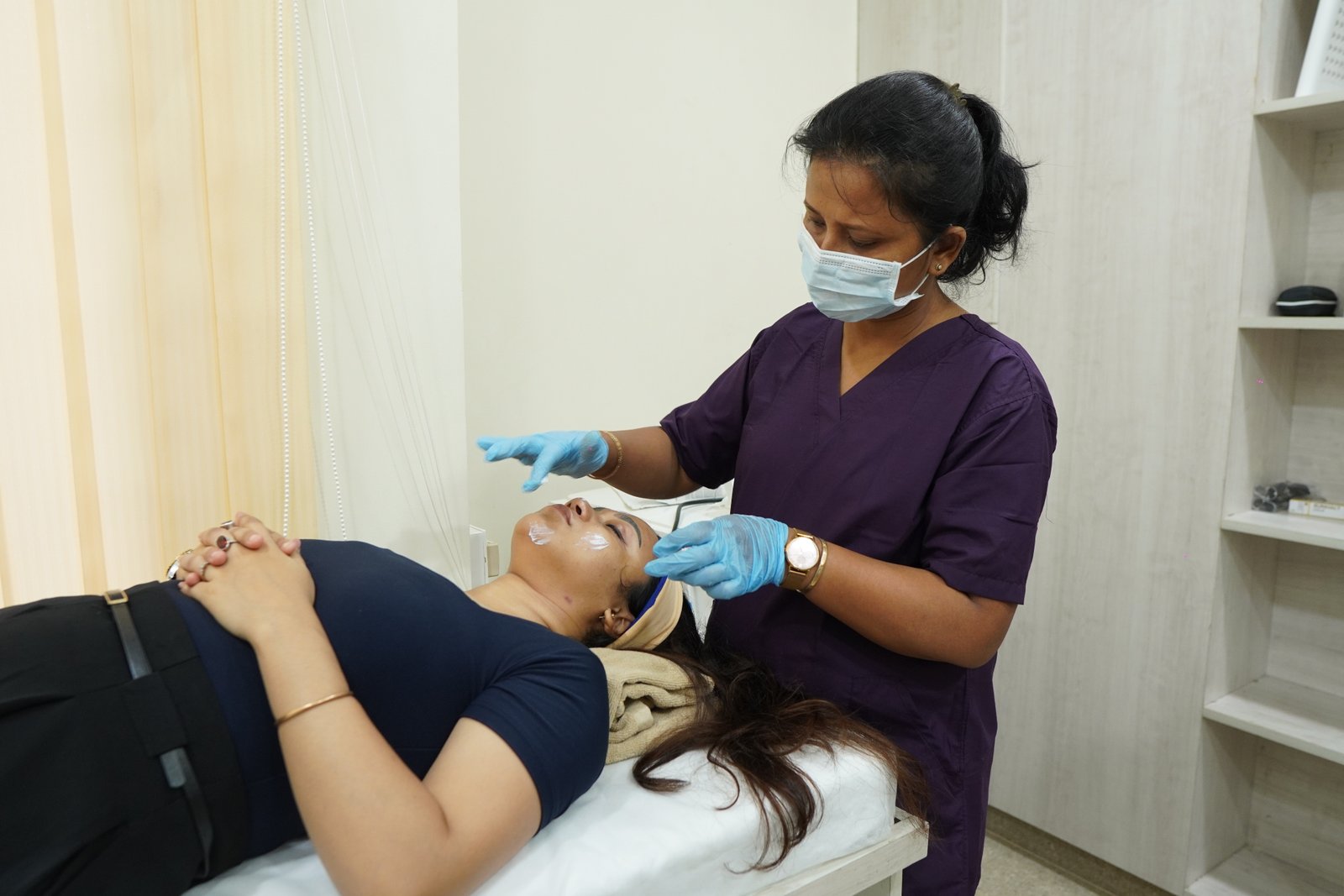Practitioner performing facial treatment at YOU FACTOR